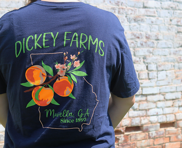 a person wearing a blue shirt that says dickey farms