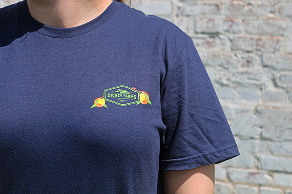 a person wearing a blue shirt that says dickey farms