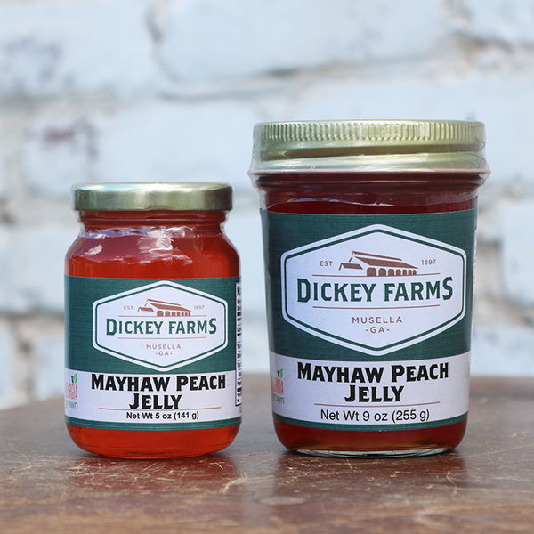 two jars of mayhaw peach jelly from dickey farms