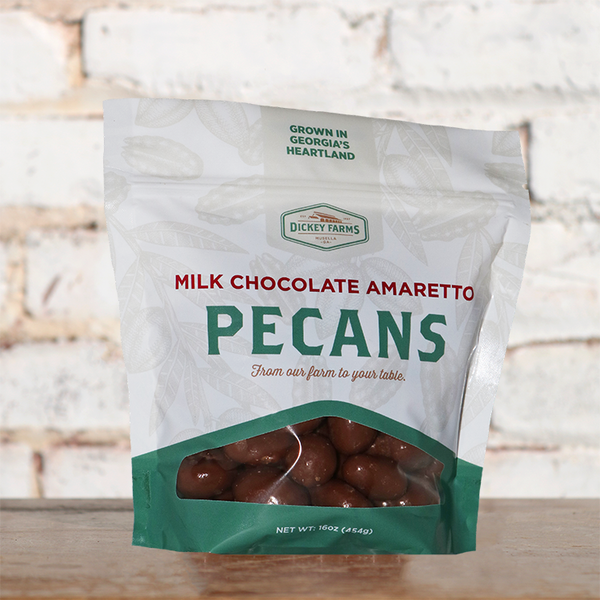 a bag of pecans is sitting on a table in front of a brick wall .