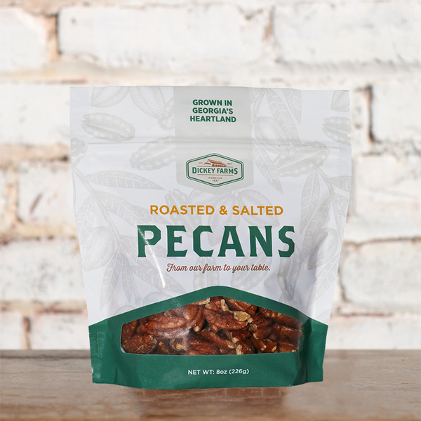 a bag of pecans is sitting on a wooden table .