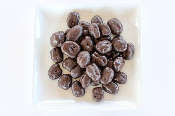a pile of chocolate covered beans on a table .