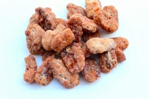 a pile of pecan pieces on a white plate .